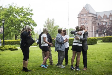Toronto, ONT.: May 30, 2019 -- Lynn Pigeau hugs lawyer Kevin Egan at Queen's Park after Lynn and two other women trekked by foot from London to Toronto to bring changes to corrections. Toronto, Ont., May 30, 2019. (Nick Kozak for Postmedia News). ORG XMIT: POS1905301829420798