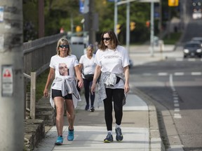 Lisa Hennessey, Rebecca McLean, and Lynn Pigeau walk along Dundas Street West near Islington Avenue as they near the end of their 184 km trek from London to Toronto to bring attention to deaths in correctional facilities (including those of their loved ones) and to inspire changes to corrections in Ontario. Toronto, Ont., May 30, 2019. (Nick Kozak for Postmedia News).