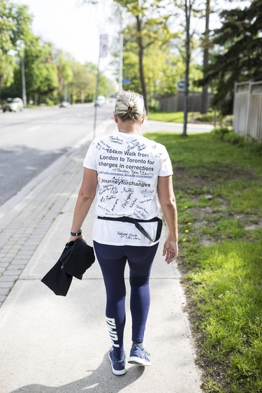 Toronto, ONT.: May 30, 2019 -- Lynn Pigeau walks along Dundas Street West near Islington Avenue on her 184 km walk from London to Toronto to bring changes to corrections. Toronto, Ont., May 30, 2019. (Nick Kozak for Postmedia News). ORG XMIT: POS1905301825340785