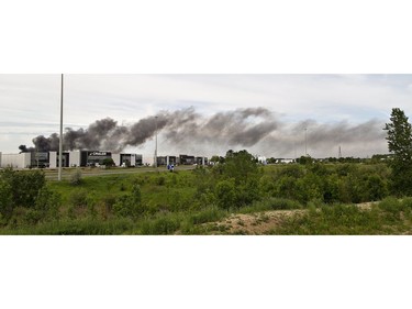 A smoke plume drifts westward from a fire at North West Rubber at 321 Henry Street on Sunday June 9, 2019 in Brantford, Ontario. Brantford Fire Department, assisted by County of Brant Fire, are battling a blaze as skids of rubber mats burn in the company's yard. North West Rubber manufactures recycled rubber flooring. Henry Street is closed from Plant Farm Road to just east of Wayne Gretzky Parkway. (Brian Thompson/Postmedia Network)