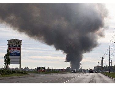 A smoke plume rises from North West Rubber at 321 Henry Street on Sunday June 9, 2019 in Brantford, Ontario. Brantford Fire Department, assisted by County of Brant Fire, are battling a blaze as skids of rubber mats burn in the company's yard. North West Rubber manufactures recycled rubber flooring. (Brian Thompson/Postmedia Network)
