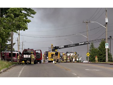 A smoke plume rises from North West Rubber at 321 Henry St. on Sunday in Brantford. Brantford Fire Department, assisted by County of Brant Fire, are battling a blaze as skids of rubber mats burn in the company's yard. North West Rubber manufactures recycled rubber flooring. Henry Street is closed from Plant Farm Road to just east of Wayne Gretzky Parkway. (Brian Thompson/Postmedia Network)