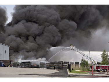 A smoke plume rises from North West Rubber at 321 Henry Street on Sunday June 9, 2019 in Brantford, Ontario. Brantford Fire Department, assisted by County of Brant Fire, are battling a blaze as skids of rubber mats burn in the company's yard. North West Rubber manufactures recycled rubber flooring. Henry Street is closed from Plant Farm Road to just east of Wayne Gretzky Parkway. (Brian Thompson/Postmedia Network)