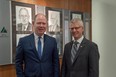 Jeff Macoun, president of Great-West Lifeco, and Richard Sifton, president of Sifton Properties, stand in front of a photo gallery of past JA London and District Business Hall of fame laureates. Macoun and Sifton were announced as the 2019 inductees Thursday. (MAX MARTIN, The London Free Press)