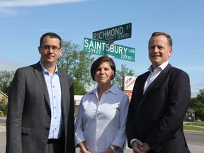 MPP Monte McNaughton, left, Lucan Biddulph Mayor Cathy Burghardt-Jesson and MPP Jeff Yurek stand at the corner of Highway 4 (Richmond Street) and Saintsbury Line. The province has agreed to pay for most of the cost of installing traffic lights at the intersection, the town's busiest. It's a project the community north of London had been eyeing for a decade. JONATHAN JUHA/THE LONDON FREE PRESS