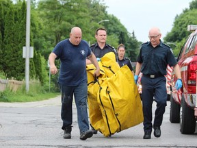 Firefighters used an inflatable boat to rescue a man found unconscious in the Thames River near the Carfrae Crescent bridge, south of Horton Street, on Thursday, June 20, 2019, in London, Ontario. (DALE CARRUTHERS, The London Free Press)