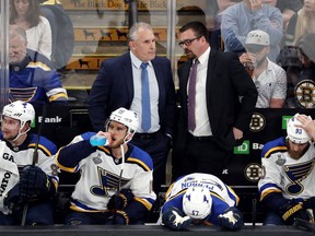 Head coach Craig Berube of the St. Louis Blues speaks with assistant coach Mike Van Ryn against the Boston Bruins during the first period in Game One of the 2019 NHL Stanley Cup Final at TD Garden on May 27, 2019 in Boston, Massachusetts.