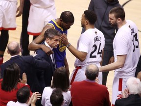 Kevin Durant #35 of the Golden State Warriors is assisted off the court after sustaining an injury in the first half against the Toronto Raptors during Game Five of the 2019 NBA Finals at Scotiabank Arena on June 10, 2019 in Toronto, Canada. (Photo by Claus Andersen/Getty Images)