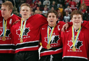 Jeff Carter #7, Corey Perry #24, Mike Richards #18 and Danny Syvret #20 of Team Canada celebrate their victory over Team Russia at the World Junior Hockey Championships at the Ralph Engelstad Arena on January 4, 2005 in Grand Forks, North Dakota. Canada defeated Russia 6-1 to win the gold medal. (Photo by Jeff Vinnick/Getty Images)