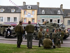 WWII enthusiasts wearing period US uniforms gather on June 5, 2019 in Sainte-Mere-Eglise, Normandy, north-western France, as part of D-Day commemorations marking the 75th anniversary of the World War II Allied landings in Normandy. (Photo by ALAIN JOCARD / AFP)ALAIN JOCARD/AFP/Getty Images