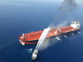 A picture obtained by AFP from Iranian news agency Tasnim on June 13, 2019 reportedly shows an Iranian navy boat trying to control fire from Norwegian owned Front Altair tanker said to have been attacked in the waters of the Gulf of Oman. - Suspected attacks left two tankers in flames in the waters of the Gulf of Oman today, sending world oil prices soaring as Iran helped rescue stricken crew members. The mystery incident, the second involving shipping in the strategic sea lane in only a few weeks, came amid spiralling tensions between Tehran and Washington, which has pointed the finger at Iran over earlier tanker attacks in May.  (Photo by - / TASNIM NEWS / AFP)-/AFP/Getty Images