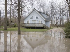 A home's front lawn is flooded on Cotterie Park Road near Point Pelee in early May.