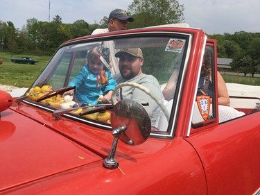Trevor Jewhurst and two-year-old Ava Jewhurst, from Newbury, get set to take a dip in an amphibious car that took guests on a trip through the pond at the Fleetwood Country Cruize-In on Saturday. (MEGAN STACEY/The London Free Press)
