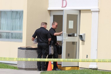 Forensic officers Sam Cook, left, and Paul Horenburg enter the Ramada hotel at 817 Exeter Rd. in London during a shooting investigation on Monday, June 17, 2019. DALE CARRUTHERS / THE LONDON FREE PRESS