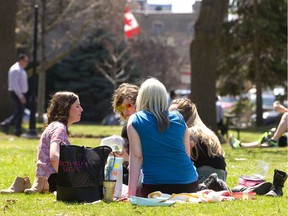 People soak up the sunshine in London’s Victoria Park. (Free Press file photo)