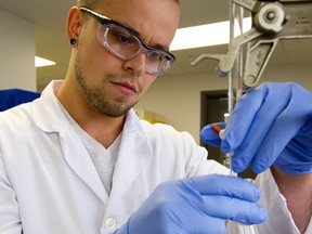 Brad Van Damme, a co-op student at Fanshawe mixes a solution in Fanshawe's new Centre for Advanced Research and Innovation in Biotechnology. They held the grand opening on Friday October 12, 2018.  (Mike Hensen/The London Free Press)