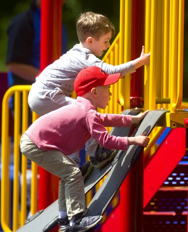 Riley Mitchell, 4 leads his buddy Luca DeActis, 4 as they climb up a flexible slide at the Springbank park playground. The two are fast friends say their moms Angela Mitchell and Ashley DeActis who say they always like to play together. Mike Hensen/The London Free Press)