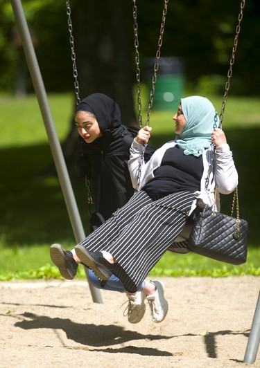 Omaima Al-Hajaly swings in Springbank Park with her daughter, Beal student Judy Kurbaj, 15, on Monday June 3, 2019. Mike Hensen/The London Free Press/Postmedia Network