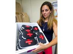 Shaya Dhinsa, sexual health manager at the Middlesex-London Heath Unit, holds up a partial shipment of naloxone kits, which is used to reverse opioid overdoses. The London area has one of the best public distribution rates for the kits in the province. (Mike Hensen/The London Free Press)
