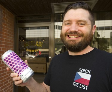 Nick Baird, one of the owners of Beerlab!, holds a can of Obi Porter outside their new location at 420 Talbot St. next door to  Milos' Craft Beer Emporium. (Mike Hensen/The London Free Press)