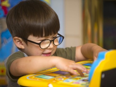 Henry Venus, 3 has an high IQ and is already being called gifted, as he plays with an electronic toy at his home in London, Ont.  Photograph taken on Tuesday June 11, 2019.  Mike Hensen/The London Free Press/Postmedia Network