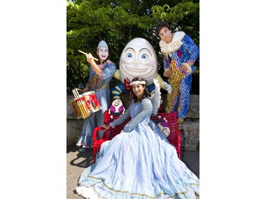 Alex Reis a drummer, Joseane Martins as Little Angel and Lolo Fernandes as Mauro of Cirque du Soleil get up close and personal with one of the residents of Storybook Gardens in Springbank Park on Wednesday June 12, 2019.  Mike Hensen/The London Free Press/Postmedia Network