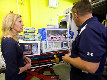 Ontario's Minister of Health Christine Elliott talks with nurse Jon Hogeterp about the neo-natal gear on a specially outfitted ambulance for transporting critically ill infants announced Thursday in London. (Mike Hensen/The London Free Press)