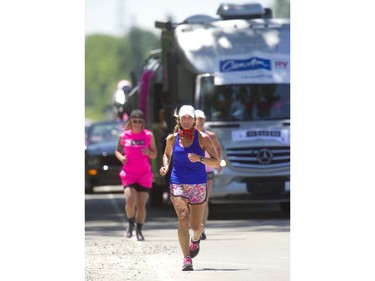 Theresa Carriere continues her 100-kilometre London-Strathroy-London Onerun fundraiser for cancer care Friday, June 14, 2019. The London breast cancer survivor wasn't alone, as a new supporter jogged alongside her every kilometre along the way. (Mike Hensen/The London Free Press)