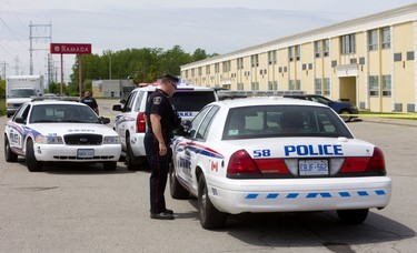 Police remain on the scene of a shooting at the Ramada Inn on Exeter Road in London on Monday. (Mike Hensen/The London Free Press)
