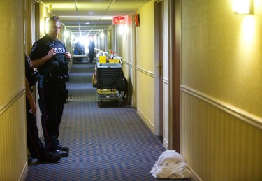 London police stand across from room 260 in the Ramada Inn after a man showed up in a London hospital with gunshot wounds Monday in London, Ont.  Photograph taken on Monday June 17, 2019.  Mike Hensen/The London Free Press/Postmedia Network
