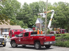 London Hydro makes repairs after a car crashed into a utility pole on Wellington Road and Frank Place and left hundreds without electricity in London on Wednesday. (Derek Ruttan/The London Free Press)
