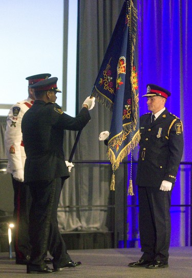New London police chief Steve Williams receives the London Police Association colours from out going chief John Pare during the change of command ceremony at the London Convention Centre  on Wednesday June 19, 2019 as he becomes the 20th London police chief. Mike Hensen/The London Free Press/Postmedia Network