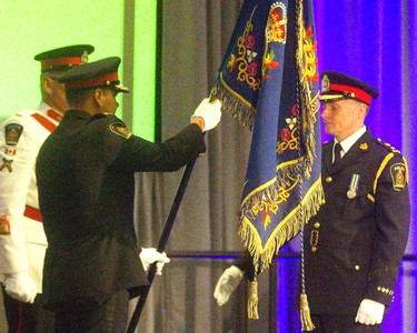 New London police chief Steve Williams receives the London Police Association colours from out going chief John Pare during the change of command ceremony at the London Convention Centre  on Wednesday June 19, 2019 as he becomes the 20th London police chief. Mike Hensen/The London Free Press/Postmedia Network