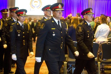 Retired chief John Pare walks out of the change of command ceremony next to London's 20th police chief, Steve Williams after the ceremony at the London Convention Centre in London, Ont.  Photograph taken on Wednesday June 19, 2019.  Mike Hensen/The London Free Press/Postmedia Network