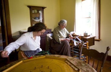 Patti Wilson and Betty Rolfe, dressed in period costumes work on their mending and weaving in the Jury homestead at the Fanshawe Pioneer Village in London, Ont.. The village was founded in 1959 and is celebrating it's 60th anniversary. Photograph taken on Thursday June 20, 2019.  Mike Hensen/The London Free Press/Postmedia Network