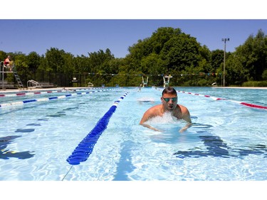 Johnny Hewerdine of the Middlesex Masters swim team warms up in Thames Pool as four London pools open to the public with the beginning of summer in London, Ont.  Photograph taken on Friday June 21, 2019.  Mike Hensen/The London Free Press/Postmedia Network