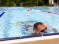 Johnny Hewerdine of the Middlesex Masters swim team comes up for a breath as he warms up in Thames Pool. Four London pools open to the public now and the rest will open June 29. (Mike Hensen/The London Free Press)