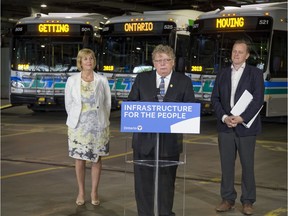 The provincial government offered up $103.5 million to fund 10 new transit infrastructure projects in London on Tuesday. A reader has noticed the slogan-like messages on the three buses behind. (Derek Ruttan/The London Free Press)