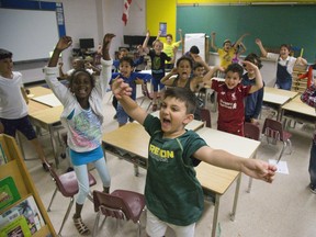 Students from Alicia Smith-Raphael's grade 1 and 2 class act like they are excited for the beginning of summer vacation at Ashley Oaks Public School. (Derek Ruttan/The London Free Press)