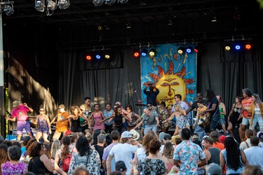 Crowd members join Gato Preto from Mozambique on stage during their performance last year.