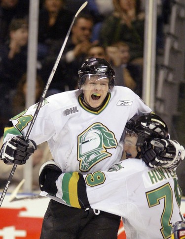 London Knights (in white) vs Erie Otters, OHL action at the John Labatt Centre, London Ontario, Mar. Knights Corey Perry leaps in the air and team mate Dylan Hunter's arms after breaking the all-time Knight's team scoring record.  Perry's assist gave him 379 points as a London Knight. The Knights won 9-1 to improve to 58-5-2-0 season.  (Dave Chidley The London Free Press)