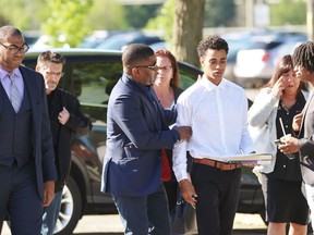 Favian Lee-Allert (white shirt) heads towards the courthouse alongside his family and defence lawyer Ramón Petgrave, far left, on Friday June 14, 2019 in Stratford, Ont. (Terry Bridge/Stratford Beacon Herald)
