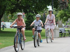 Cutline: Rebecca Henderson (right) and her children, Norah, 10 and Oscar, 8, ride their bikes in Victoria Park. Henderson is a Western University PhD candidate who's working with city hall on collecting local cycling data.