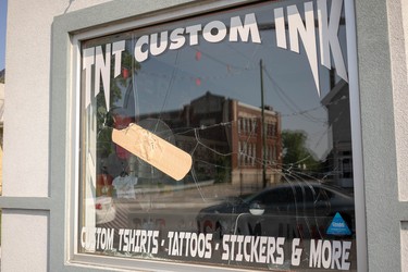 Hamilton Road business TNT Custom Ink placed an jumbo bandage sticker over a crack in its window after it was smashed for the second time this year, and employee said. (Max Martin/London Free Press)