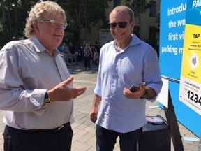 Mayor Ed Holder, left, learns how to use a new parking payment technology HonkTap from  Honk Mobile CEO Michael Back. London is using the technology at all its parking lots and parking meters. (HEATHER RIVERS, The London Free Press)