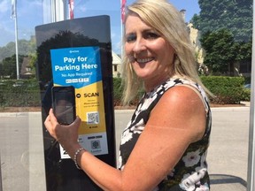 Annette Drost, manager of parking service, shows off how to use your cell phone to pay for parking using new technology called HonkTAP.  London is the first city in the world to use the tap or scan app. (HEATHER RIVERS, The London Free Press)