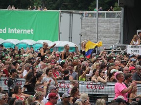 Fans enjoy Pitbull’s performance at Rock the Park Saturday just before a storm forced them to temporarily leave Harris Park. (SEBASTIAN BRON, The London Free Press)