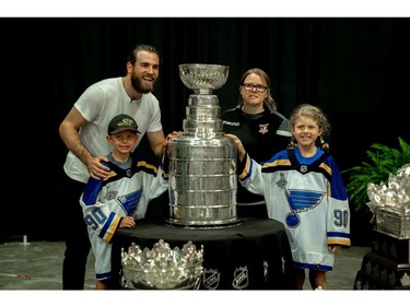 Denny MacDonald, 7, sister Kyla MacDonald, 9, and aunt Kayleigh Pickard pose for a photo with hockey star Ryan O'Reilly. (MAX MARTIN, The London Free Press)