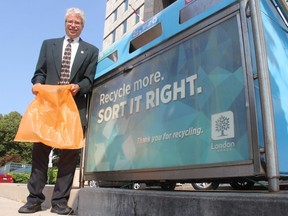 Jay Stanford, city hall's environment boss, shows an orange "hefty energy bag," which city staff are proposing to use for a pilot project - the first of its kind in Canada - that aims to diver hard-to-recycle plastics from ending up in the landfill. JONATHAN JUHA/THE LONDON FREE PRESS