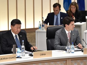 China's President Xi Jinping (L) and Prime Minister Justin Trudeau (R) attend a session at the G20 Summit on June 29, 2019 in Osaka, Japan. Tensions are running very high between Canada and China.